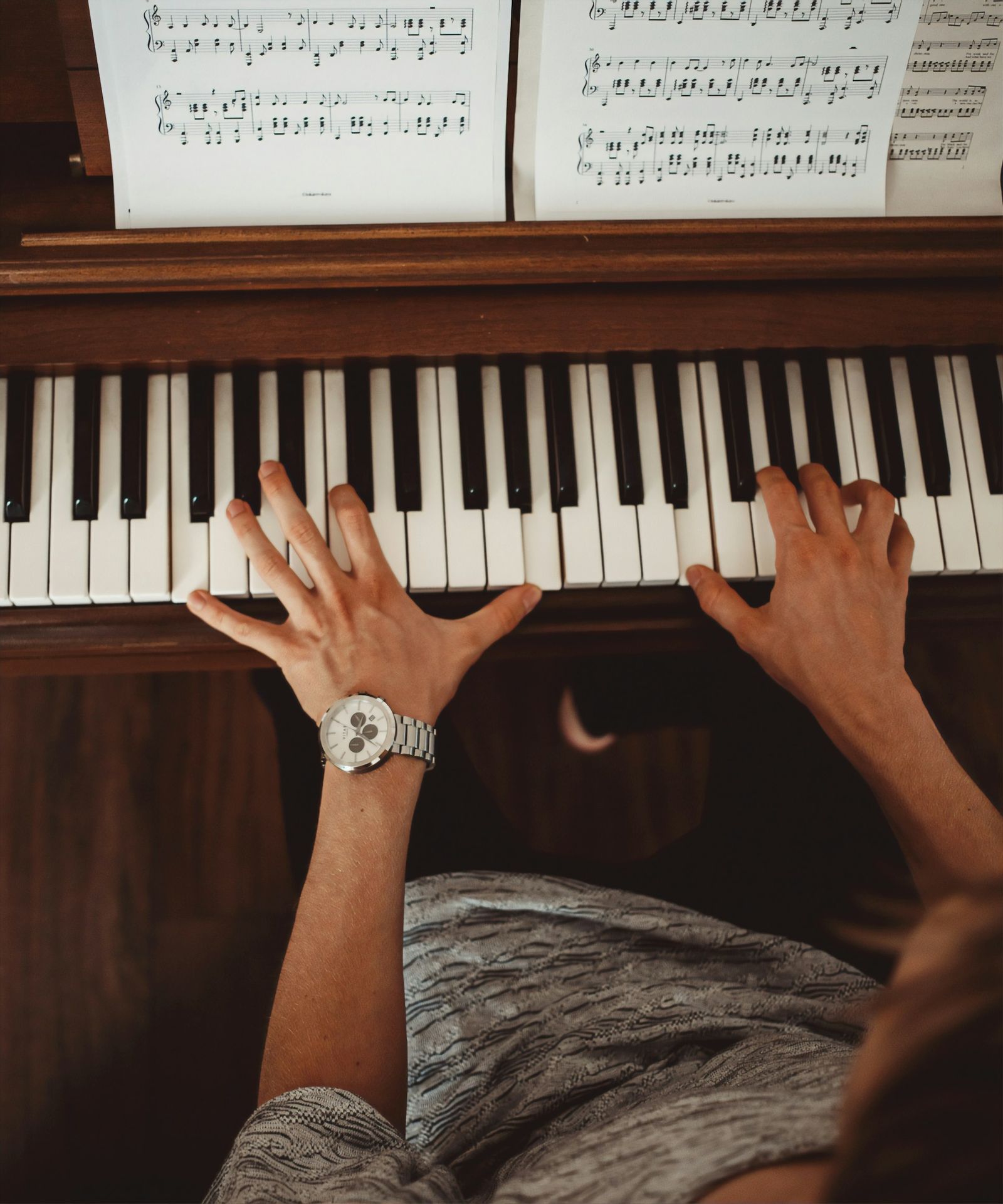 person wearing silver link bracelet round analog watch